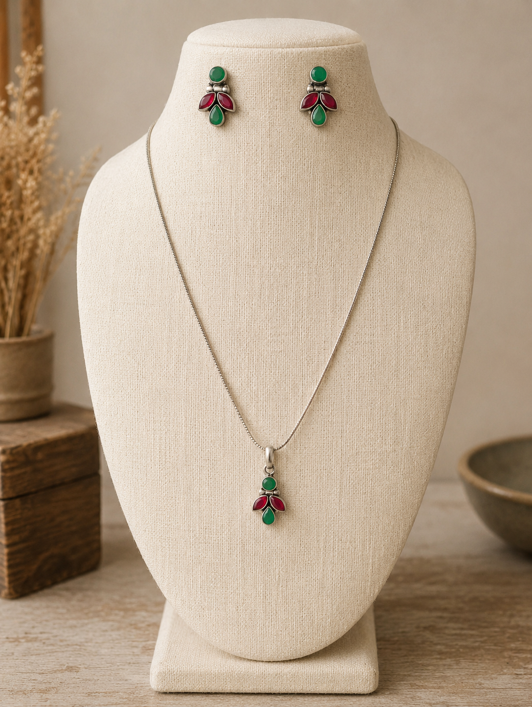 Jewelry set with necklace and earrings on a mannequin bust.