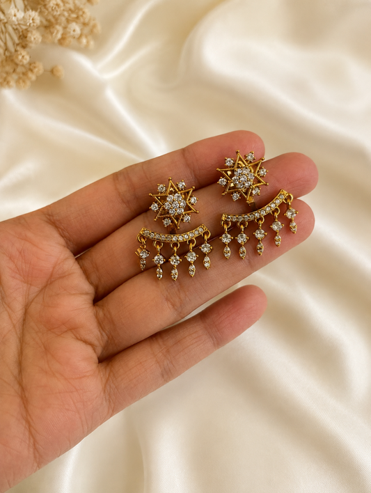 Elevate your jewelry collection with these exquisite 2-in-1 convertible ear jackets, designed to offer seamless transitions from daytime elegance to evening glamour. At the center of this versatile design are brilliant, starburst-shaped studs intricately encrusted with high-quality diamond replicas that radiate celestial charm. For a more dramatic, statement-making look, the studs seamlessly pair with detachable crescent-shaped ear jackets that feature five delicate, cascading pavé droplets designed to hug 