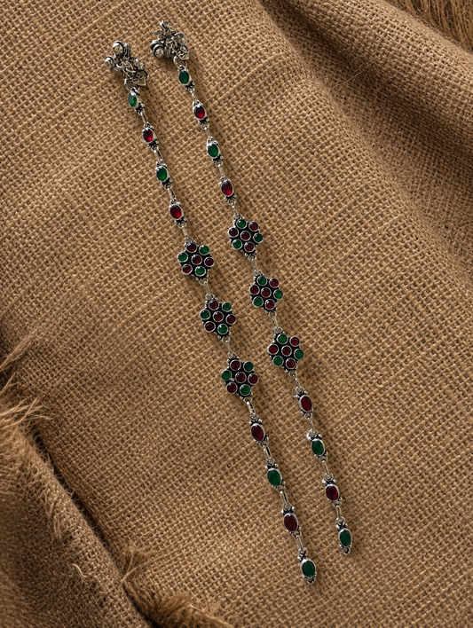 Decorative necklace with floral designs on a brown fabric background
