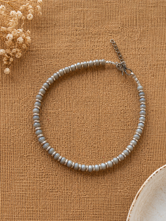 Pearl Anklet on a textured brown surface with dried flowers