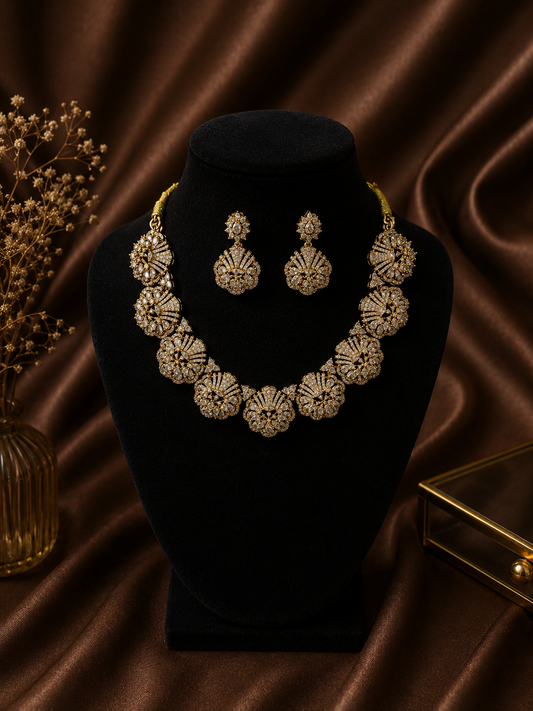A premium gold-plated bridal jewelry set displayed on a rich brown satin fabric, featuring a thick choker necklace made of large, interconnected circular floral motifs densely packed with uncut white AD stones, paired with matching statement drop earrings.