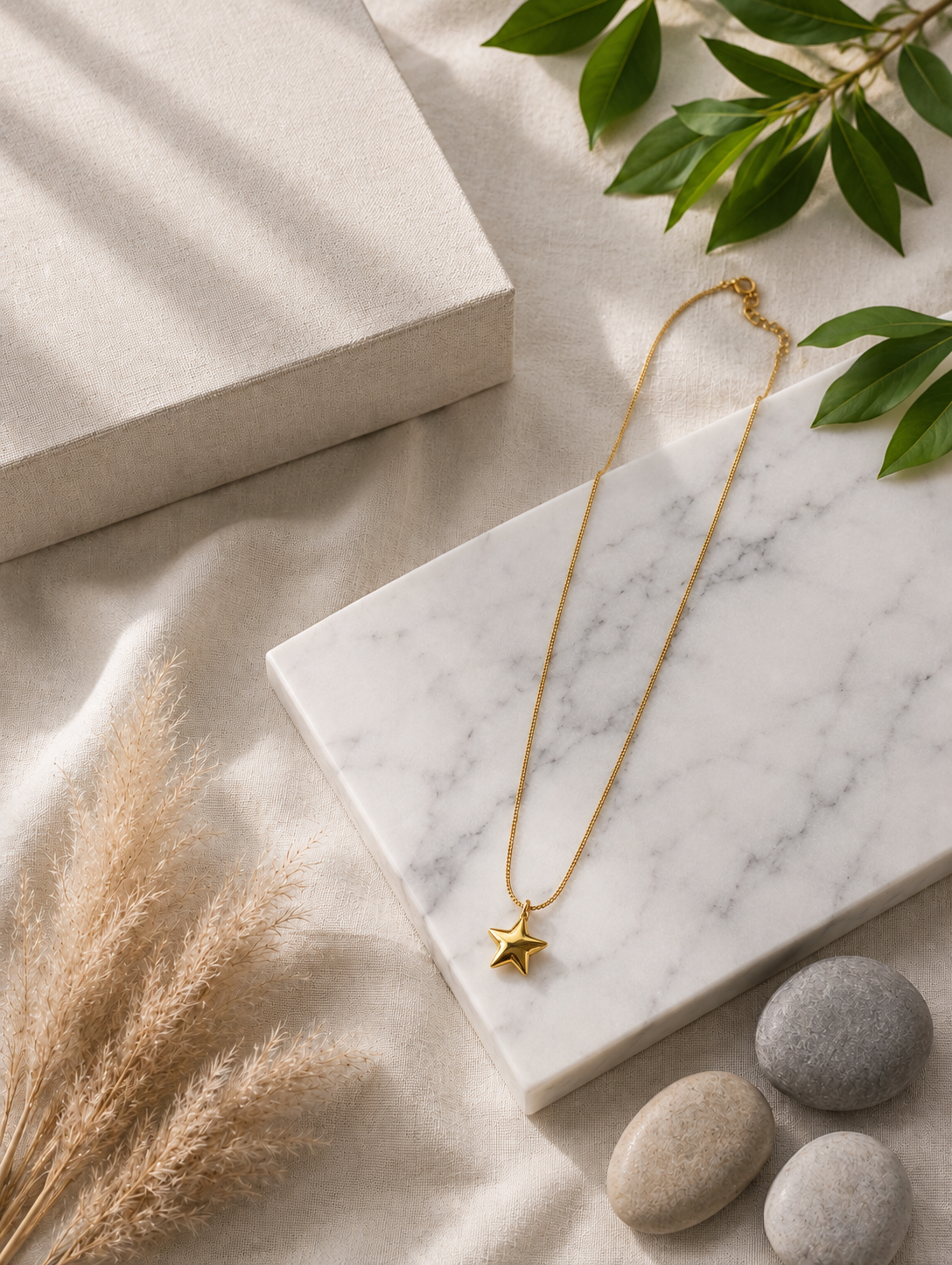 Here is a comprehensive, one-paragraph alt text for **GN016_star chain.png**, balancing descriptive detail with conciseness for an e-commerce or catalog setting:

> A close-up photograph focusing on a woman's neck and collarbone, highlighting a minimalist gold necklace. The piece features a delicate, thin gold chain carrying a polished, three-dimensional five-pointed star pendant that rests flat against her skin. The model, showing her jawline, soft dark updos, and a cream strapless top, is captured in warm