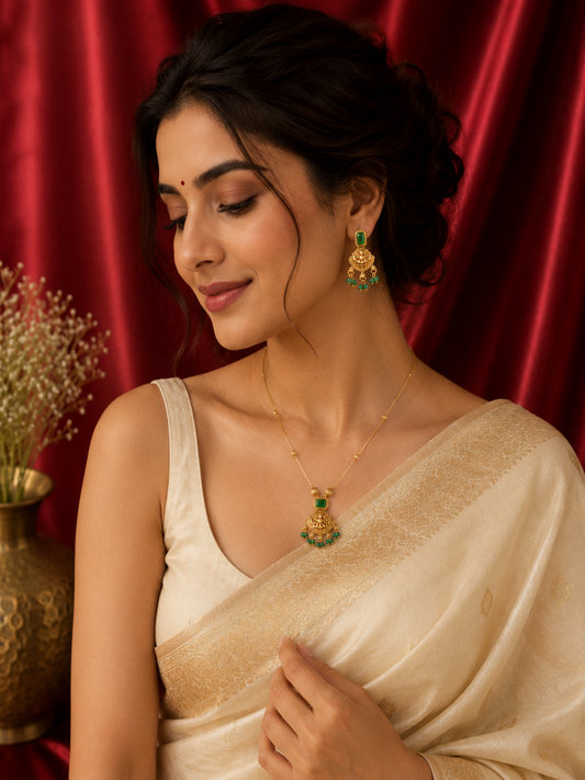 Woman wearing traditional jewelry against a red curtain background