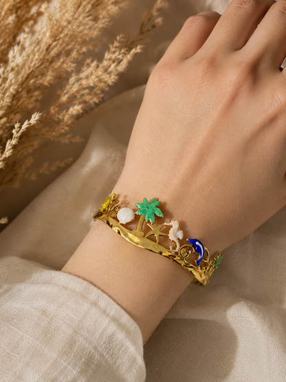 Gold bracelet with colorful stones on a wrist against a neutral background