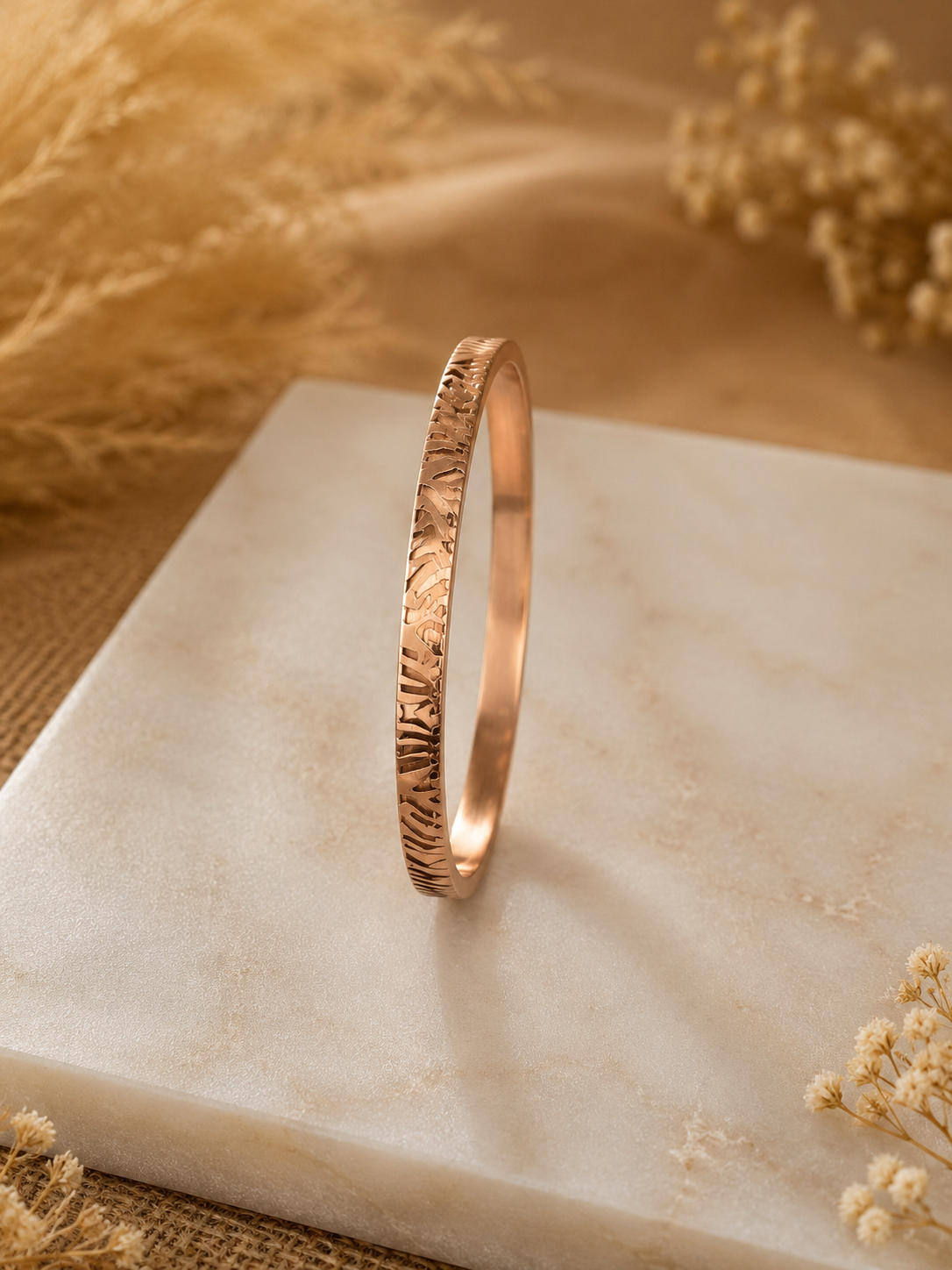Antica Designs premium gold-toned rigid kada bracelet featuring an intricately engraved textured tiger stripe pattern.