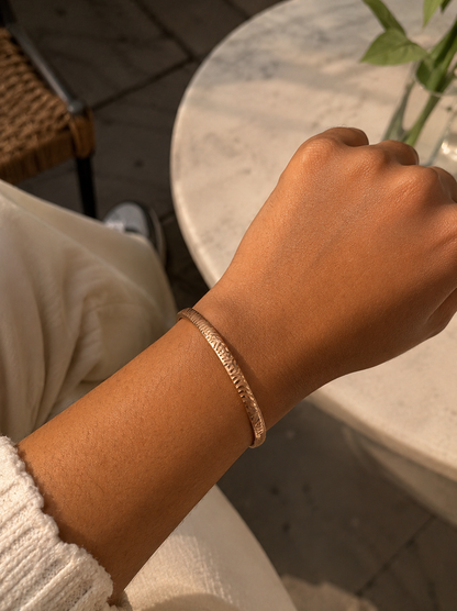 Antica Designs premium gold-toned rigid kada bracelet featuring an intricately engraved textured tiger stripe pattern.