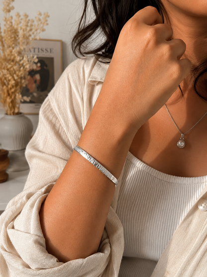 Antica Designs sleek silver-toned hinged bangle with an etched tactile tiger print pattern.