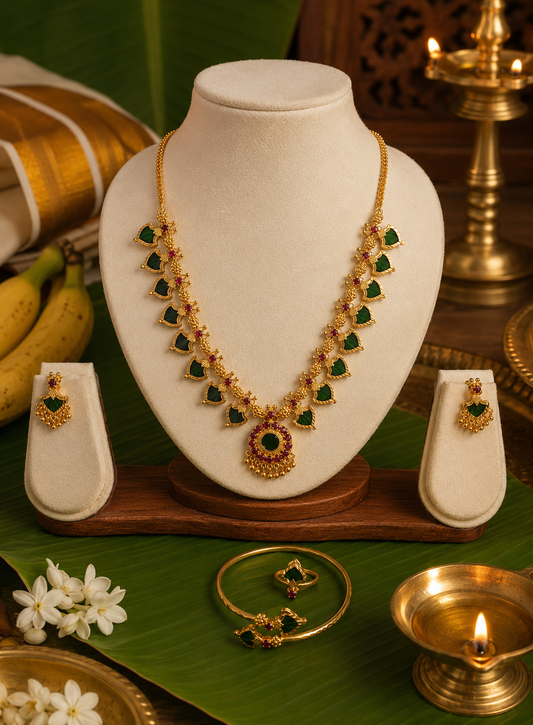 Celebrate the timeless beauty of Kerala tradition with this elegant Palakka Combo Jewelry Set, featuring a matching necklace, earrings, adjustable ring, and kada. Crafted with a premium gold finish and intricate detailing, this lightweight set is perfect for weddings, festivals, temple visits, and ethnic occasions. A graceful addition to every traditional jewelry collection.