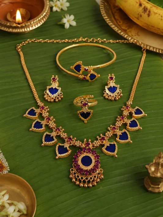 Celebrate the timeless beauty of Kerala tradition with this elegant Palakka Combo Jewelry Set, featuring a matching necklace, earrings, adjustable ring, and kada. Crafted with a premium gold finish and intricate detailing, this lightweight set is perfect for weddings, festivals, temple visits, and ethnic occasions. A graceful addition to every traditional jewelry collection.