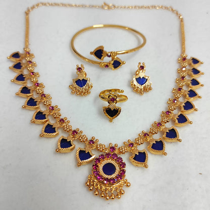 Gold jewelry set with blue and red stones on a white background