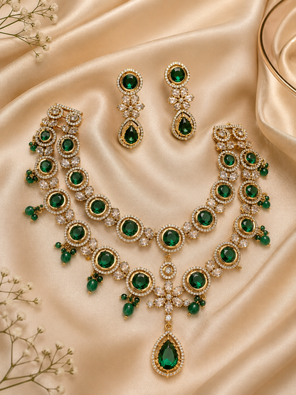 Green gemstone necklace and earrings on beige fabric