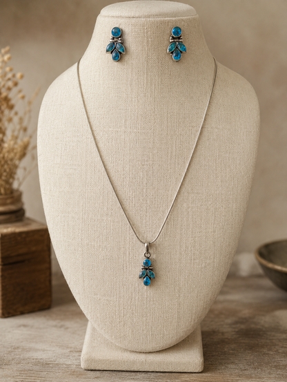 Jewelry set with necklace and earrings on a beige mannequin bust.