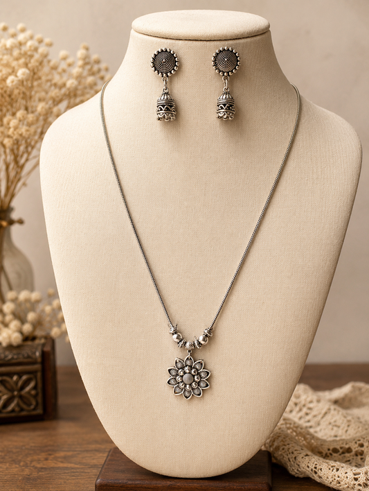 Jewelry set with necklace and earrings on a mannequin bust.