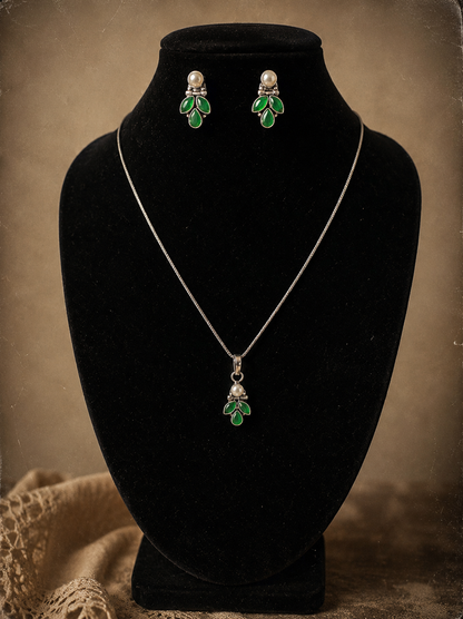 Jewelry set with necklace and earrings on a black velvet stand against a brown background