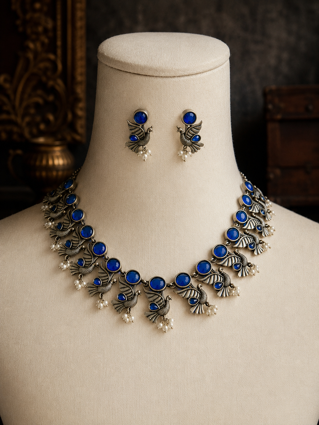 Jewelry set with necklace and earrings on a mannequin bust.