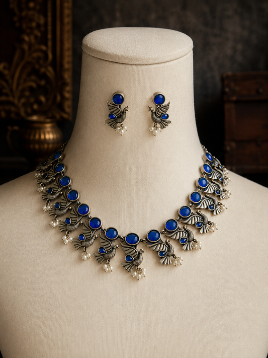 Jewelry set with necklace and earrings on a mannequin bust.