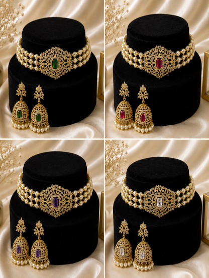 Set of gold and pearl jewelry on a black cushion with a white satin background