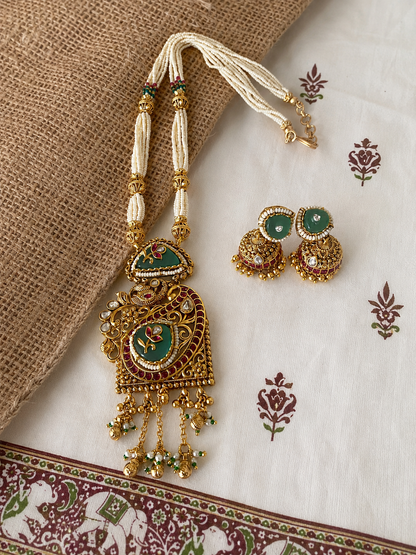 Antique gold pearl haram necklace set with a large green enamel pendant and matching Indian Jhumkas, ideal for bridal and ethnic festive wear.