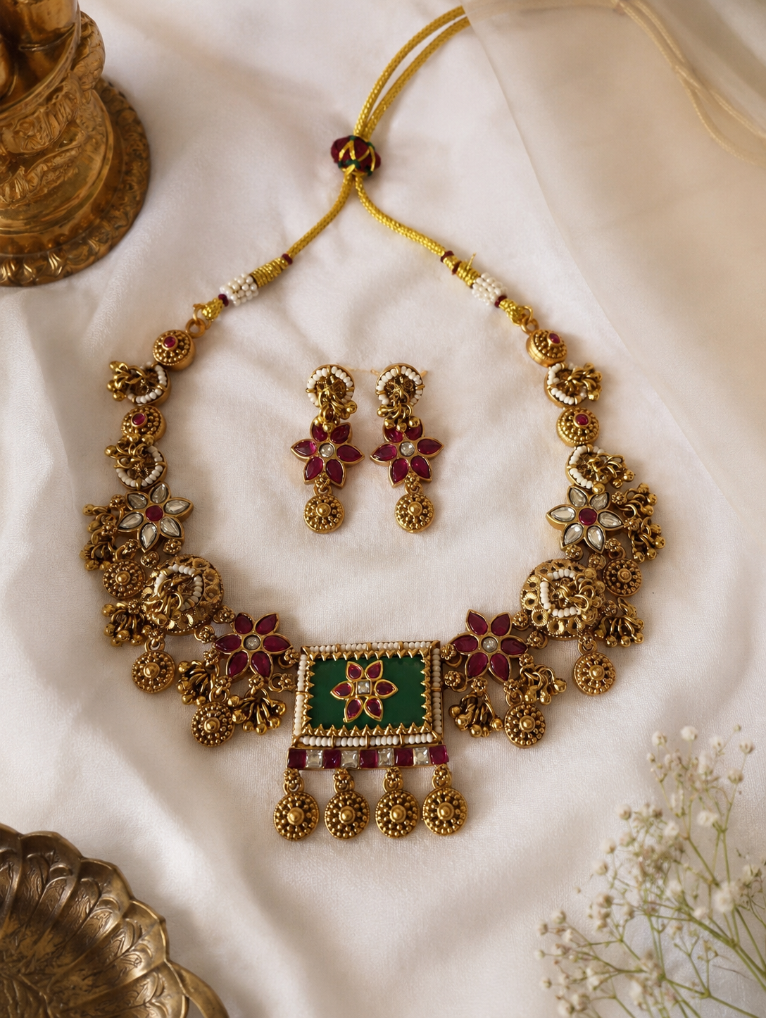 Indian antique gold-plated choker jewelry set with ruby stones and green Meenakari artwork, designed for weddings, festivals, and ethnic traditional wear.