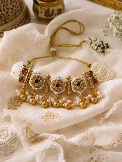 Indian royal Rajputi pearl choker necklace set with intricate antique gold Kundan work and hanging pearl drops for traditional bridal, wedding, and festive occasions.