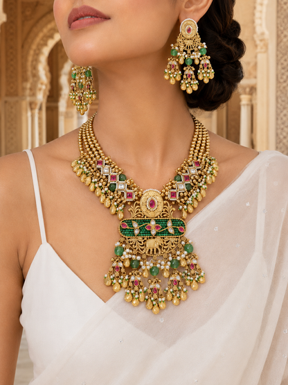 Woman wearing a gold necklace and earrings with gemstones in an ornate setting
