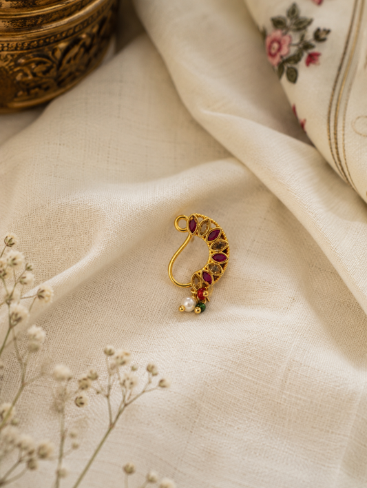 Gold-plated press-on crescent Nath studded with marquise-cut ruby red and clear stones, featuring dangling pearl and colored bead drops.