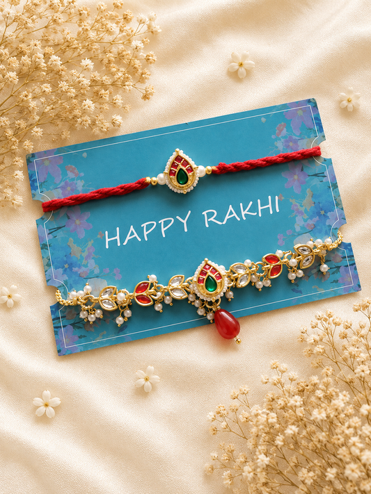 Handcrafted Bhaiya Bhabhi Rakhi set featuring an intricate gold-toned Lumba chain bracelet with red, green, and white Meenakari accents beside a matching thread Rakhi.