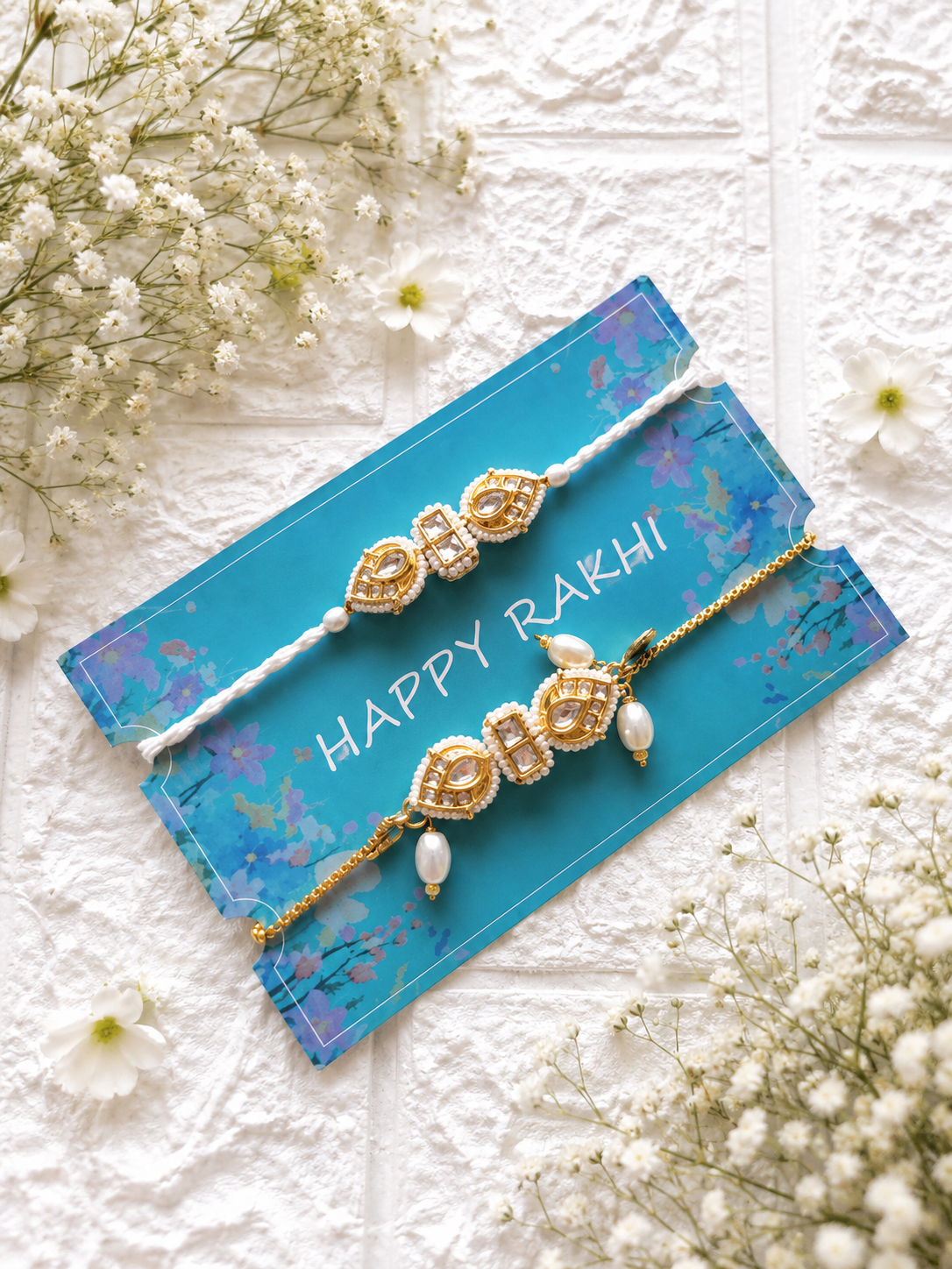 Handcrafted Bhaiya Bhabhi Rakhi set featuring a gold-toned Kundan Lumba bracelet with hanging pearl drops beside a matching white Kundan thread Rakhi.
